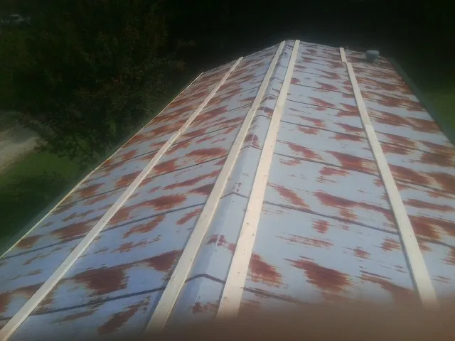 Rusted metal roof panels with new wood purlins before replacement — Storm Damage Roof Repair in Rockport by Roofing Brothers